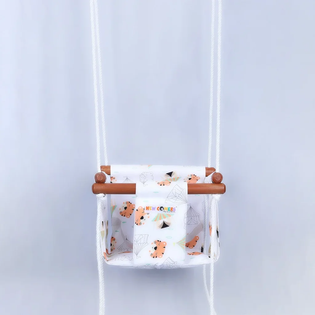 baby swing with white colored , baby tiger printed on cotton garment. Portable Small beby jhula with polished wooden frames and ropes