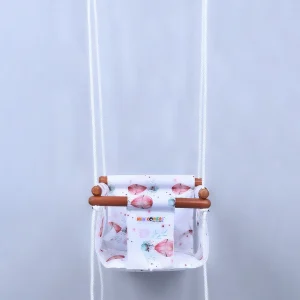 white fabric jhula for babies with small parachute prints, hanging with four ropes passings through wooden jhula frames