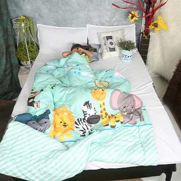 a happy child playing with blue and orange comforter on his bed