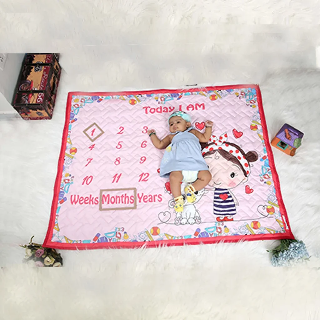 Pink monthly milestone blanket with girl and her cat sharing a bond of love cartoon print muslin quilt blankets with baby sleeping on it by newcomers