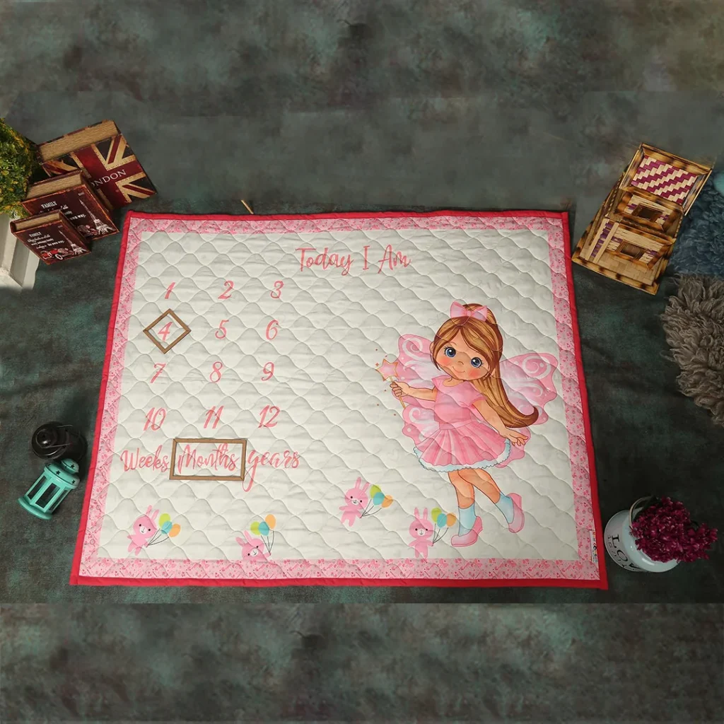 Off white pink fabric new born milestone blanket with a cute girl cartoon print milestone quilt by newcomers