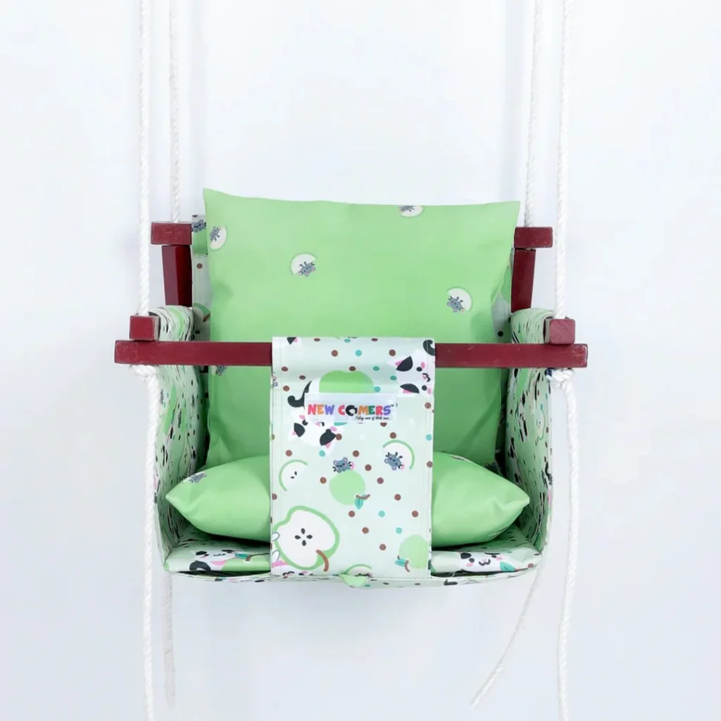 green apple colorful print baby sleeping swing for online baby jhula shopping, with light green colored pillows made by newcomers brand