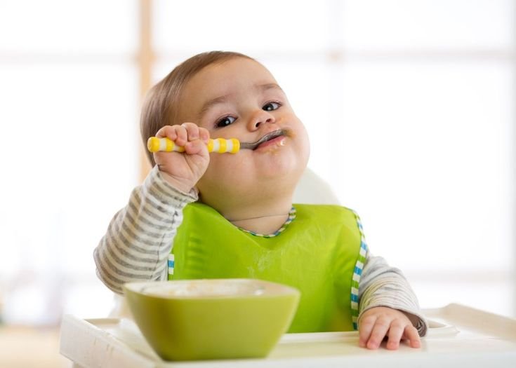 Baby eating cerelac baby food