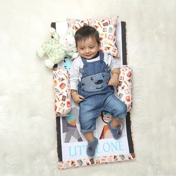 baby sleeping on baby bedding set that comes with bed mattress, a pillow and bolster made by newcomers